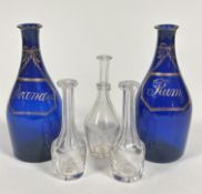 A pair of Regency bristol blue glass mallet shaped rum and brandy decanters with gilt style