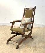 A late 19th/ early 20th century upholstered mahogany framed American rocker, on rear ceramic