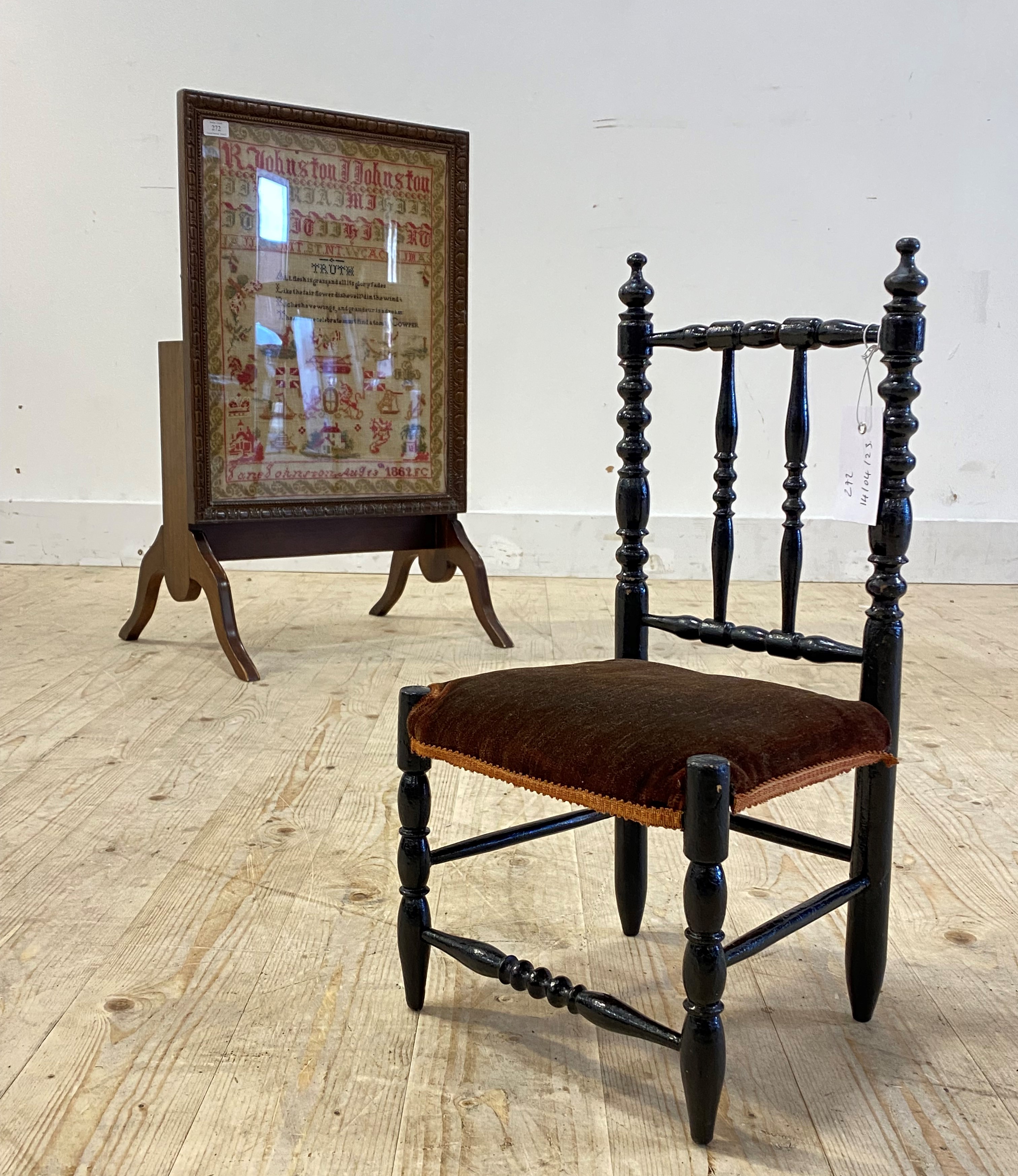 A Victorian needlework sampler, dated 1862, within a later glazed mahogany metamorphic table fire