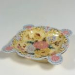 A Zsolnay Pecs, scalloped shaped dish with pierced boarder decorated with chrysanthemum design to