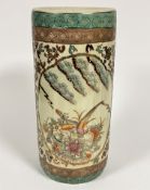 A Japanese pottery cylinder stick stand decorated with exotic birds, leaves and chrysanthemums, with