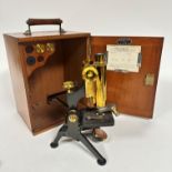 A mahogany case with brass mounted mahogany handle containing a brass and iron microscope, W