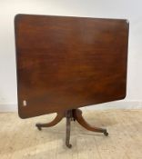 A George III mahogany tilt top breakfast table, the square top with reeded edge over ring turned