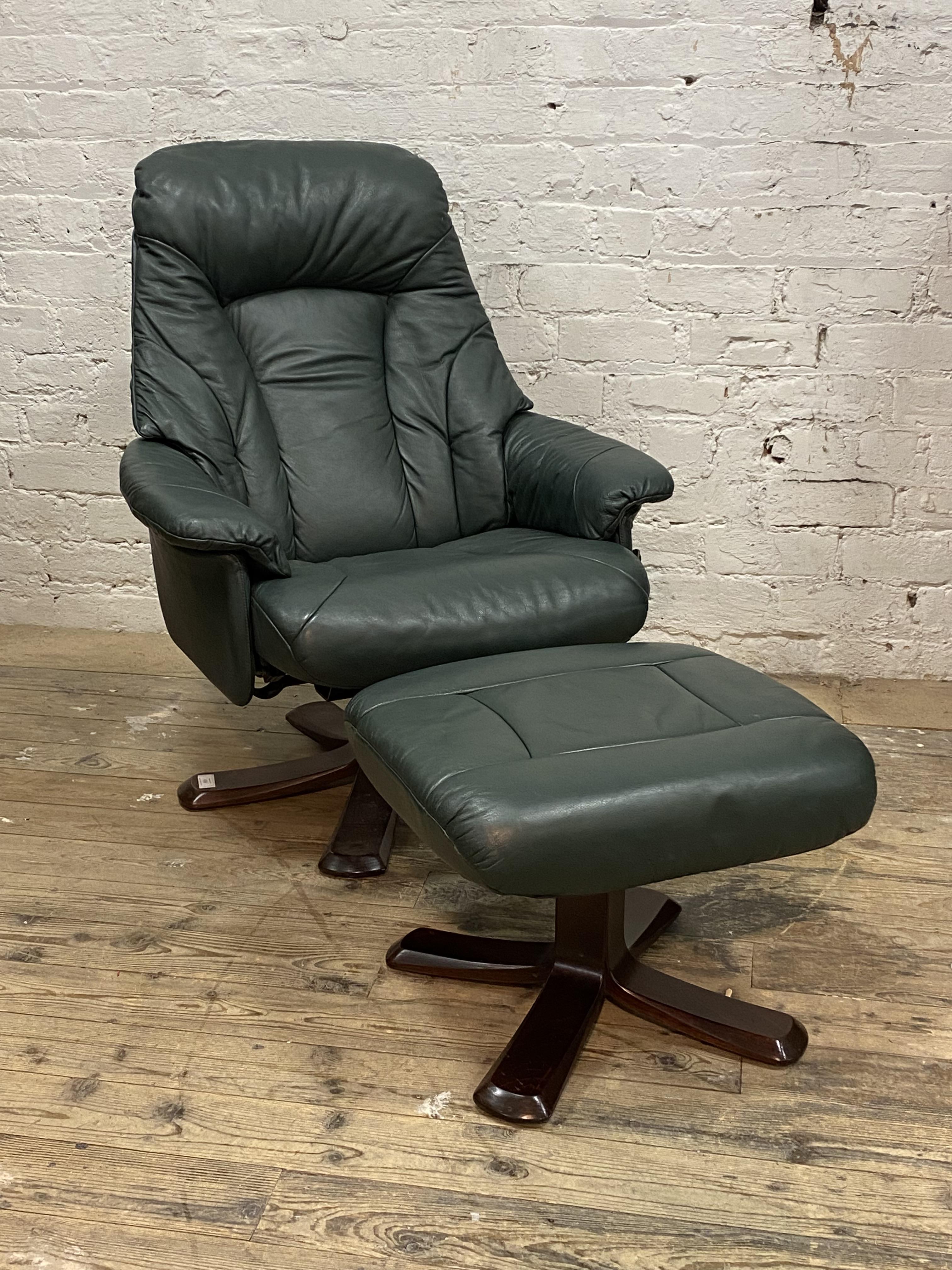 A vintage green leather upholstered reclining easy chair and footstool H102cm