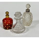 A 19thc cranberry glass perfume bottle of panelled design with gilt leaf decorated all over