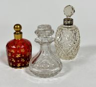 A 19thc cranberry glass perfume bottle of panelled design with gilt leaf decorated all over