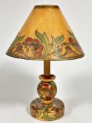 A 1920s birch wood table lamp with original card tube lined and painted shade and matching ball