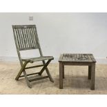 A pair of slatted silvered teak folding garden chairs (H95cm) together with a matching low table (