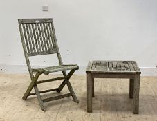 A pair of slatted silvered teak folding garden chairs (H95cm) together with a matching low table (