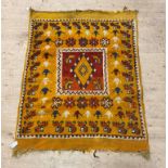 A vintage hand knotted Moroccan rug, the orange ground with stylised animal motif, 150cm x 115cm