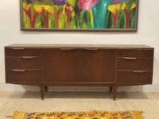 McIntosh, a mid century teak sideboard, fitted with a cupboard flanked by six drawers, raised on