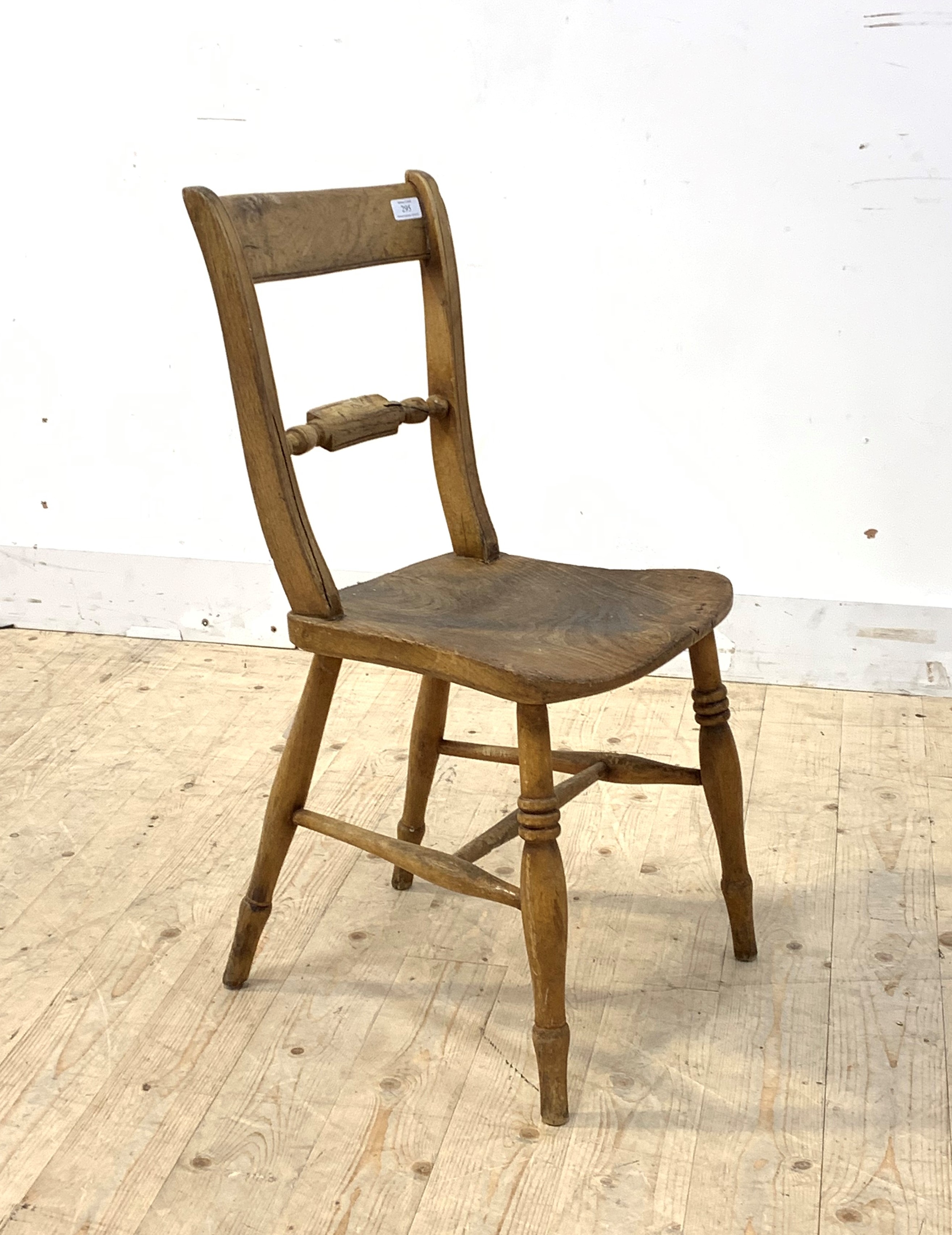 An early 19th century elm and beech vernacular rail back chair with ring turned supports, H81cm