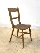 An early 19th century elm and beech vernacular rail back chair with ring turned supports, H81cm