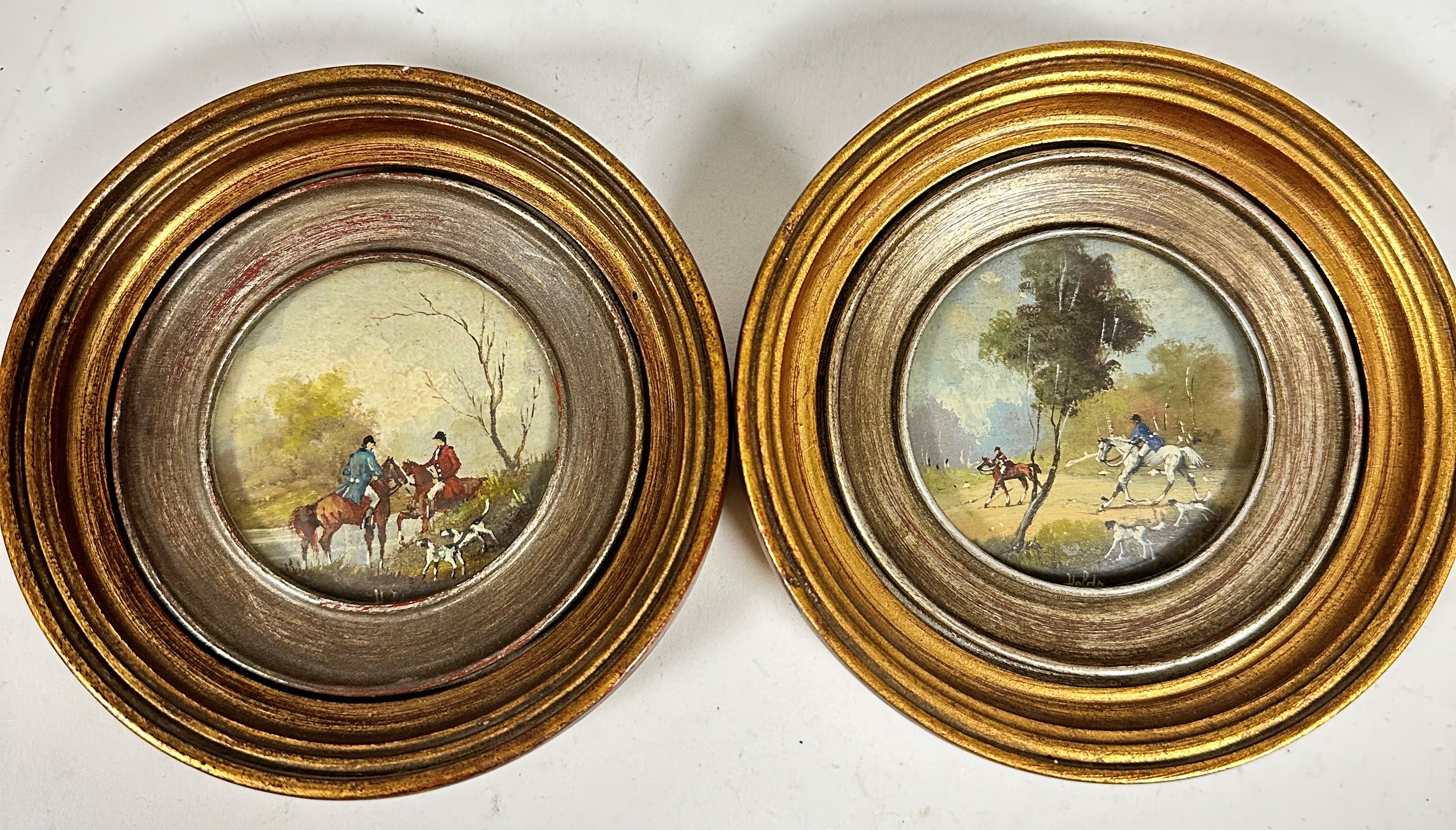 Two miniature paintings on panel depicting hunting scenes with figures on horseback and hounds, in