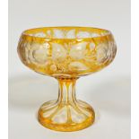 A large amber to clear slice cut fruit bowl with stylised flowers, leaves and panels, on faceted cut