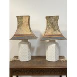 A pair of Italian white ceramic table lights of hexagonal outline with lozenge motif H68cm (