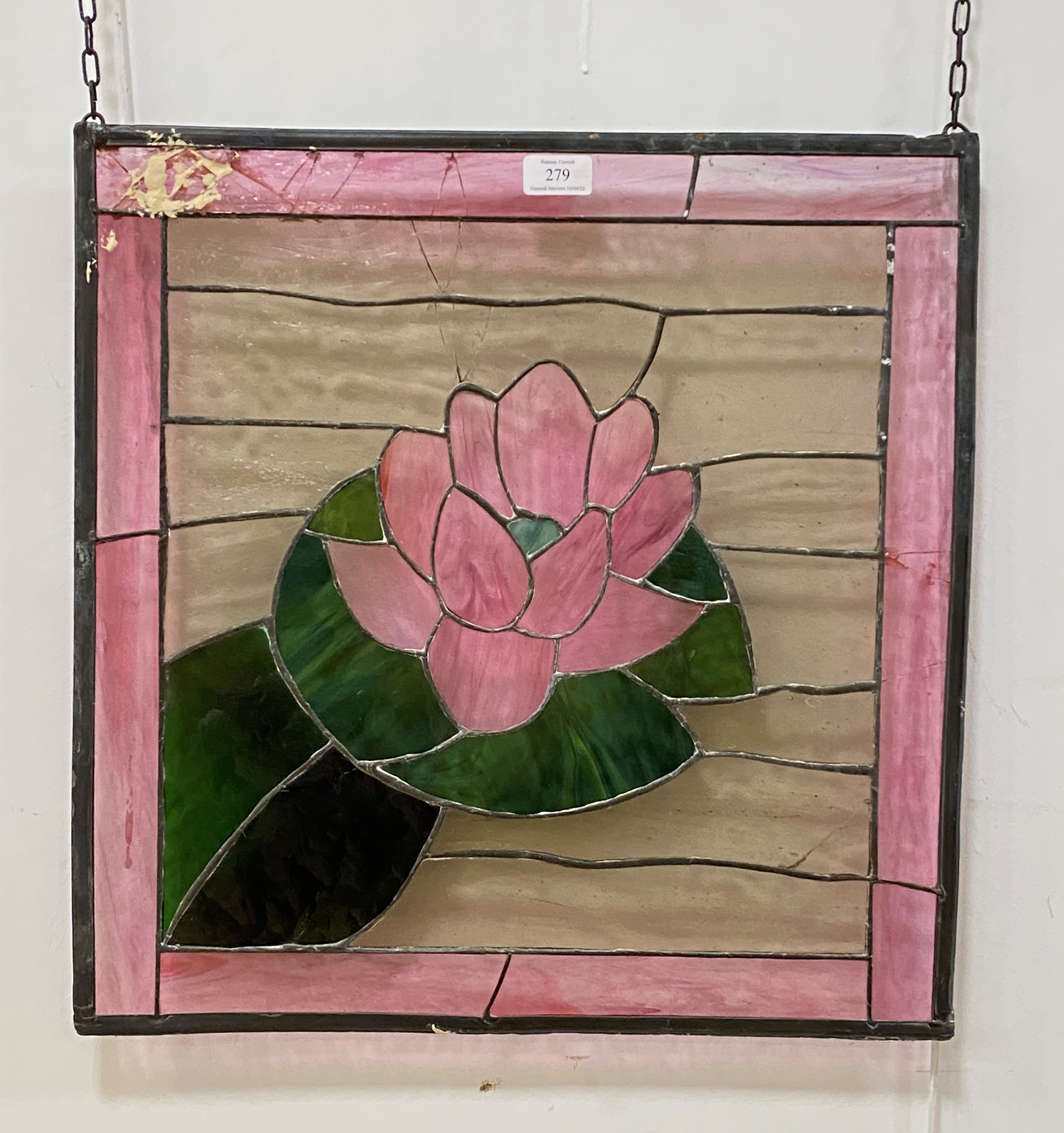 A stained and lead glazed window panel, the centre depicting a water lily 50cm x 51cm