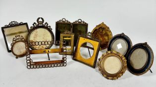 A pair of Edwardian brass oval blue velvet mounted photograph frames with easel stands and rings