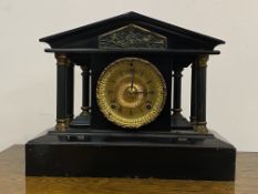 A late 19th century American black painted metal mantel clock of architectural form, the gilt dial