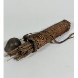 A South American straw container with gourd top and woven string cord containing a collection of