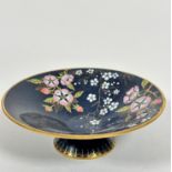 A Carlton Ware blue circular pedestal dish decorated with stylised dog rose and blossom design