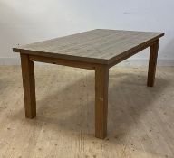 A pine dining table, raised on square section supports, H75cm, 101cm x 180cm