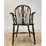 An early 20th century ash and beech Windsor chair, hoop and spindle back over shaped seat and turned