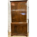 A Georgian style mahogany bookcase cabinet, the twin panelled doors enclosing three adjustable