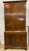 A Georgian style mahogany bookcase cabinet, the twin panelled doors enclosing three adjustable