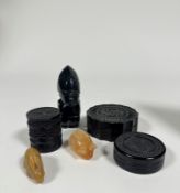 A set of three small wooden boxes, decorated in various abstract designs, an obsidian glass