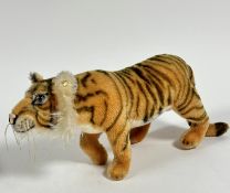 A German Steiff plush mohair tiger with inset glass eyes and stud to ear, (h 19cm, excluding tail