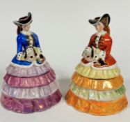 A pair of AE Gray & Co of Hamley china figure lady biscuit containers decorated with polychrome
