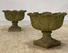 A pair of reconstituted stone planters of scrolling leaf form H43cm, D51cm