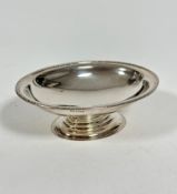 A modern oval silver bon bon dish with floral style chased border, raised on oval stepped base,