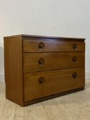 A mid century teak chest, circa 1960's, fitted with three graduated drawers H71cm, W103cm, D42cm