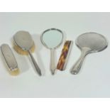 A London silver Mappin & Webb engine turned decorated four piece dressing table brush set