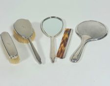 A London silver Mappin & Webb engine turned decorated four piece dressing table brush set