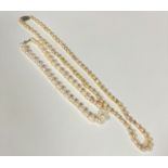 A baroque pearl necklace with white metal clasp fastening set CZ's, (L 36cm) and a modern cultured