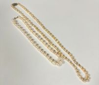 A baroque pearl necklace with white metal clasp fastening set CZ's, (L 36cm) and a modern cultured