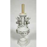 A Meissen blanc de chine porcelain baluster vase lamp, the moulded top with twin putti figures