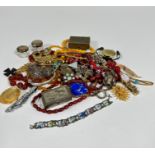A collection of amberoid graduated bead necklaces, glass enamelled bead necklace, paste brooches,