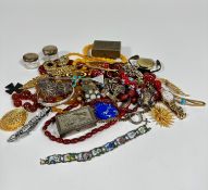 A collection of amberoid graduated bead necklaces, glass enamelled bead necklace, paste brooches,