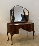 An early 20th century mahogany dressing table, with triptych mirror over one long and four short