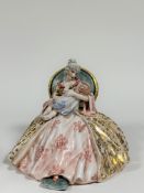 A Capodimonte style porcelain figure of a seated lady holding a child. (marked verso) ( h-27cm w-