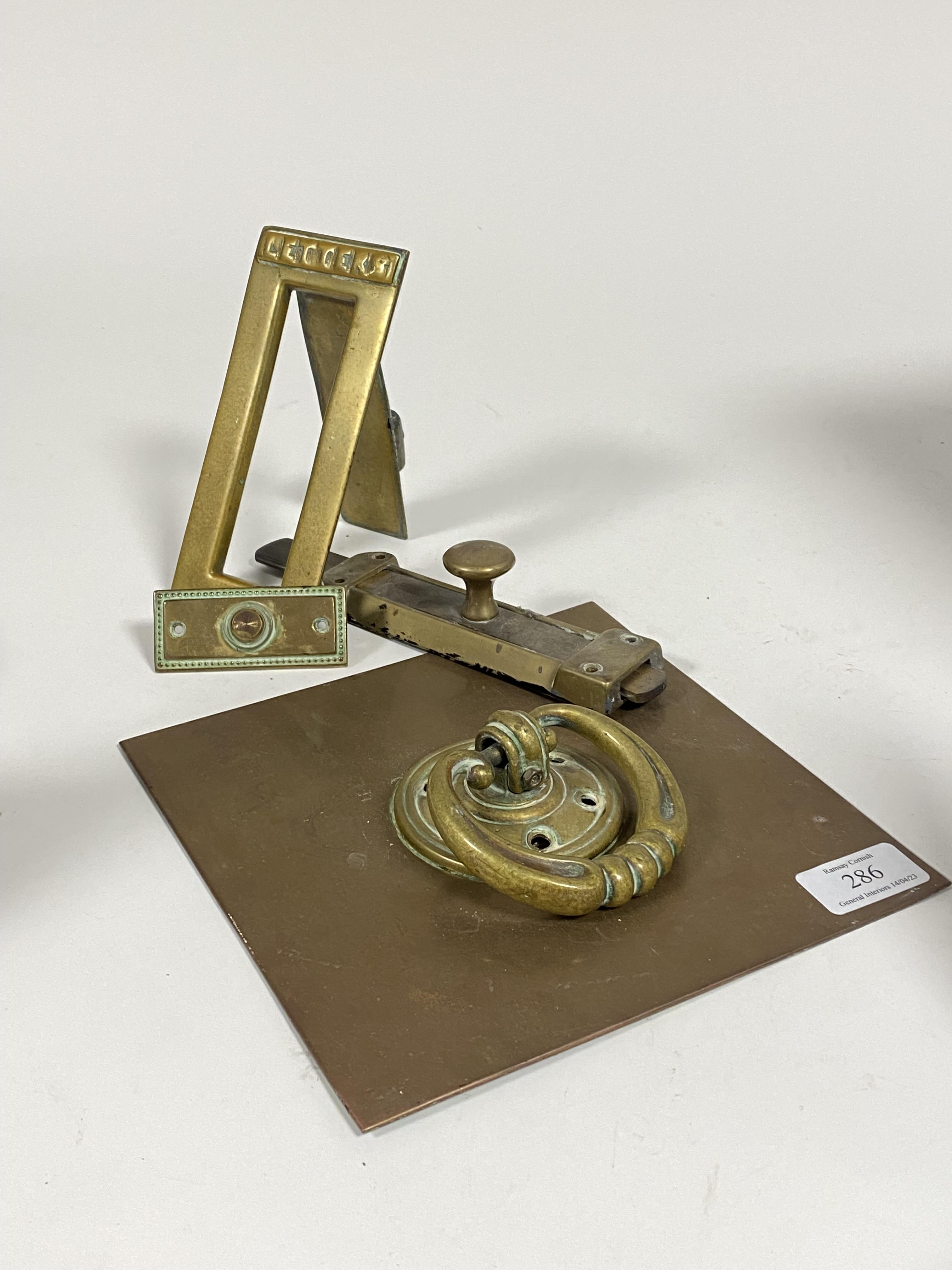 A collection of brass door furniture, to include a late 19th century brass door knocker and back