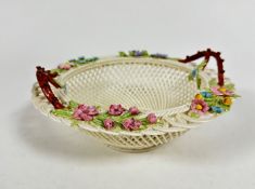 A Belleek Irish porcelain twin handled basket with open woven border, with floral painted
