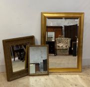 A group of three gilt framed wall mirrors