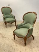 A pair of Victorian walnut framed drawing room spoon back chairs, upholstered in green and raised on