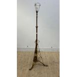 An early 20th century brass standard lamp on triple splay paw supports, H138cm (excluding bulb)