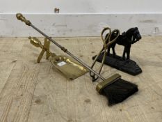 A 19th century cast iron door stop in the form of a horse, together with a pair of brass fire tongs,